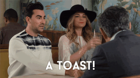 David and Alexis Rose clink glasses with their father in Schitt's Creek, saying A TOAST